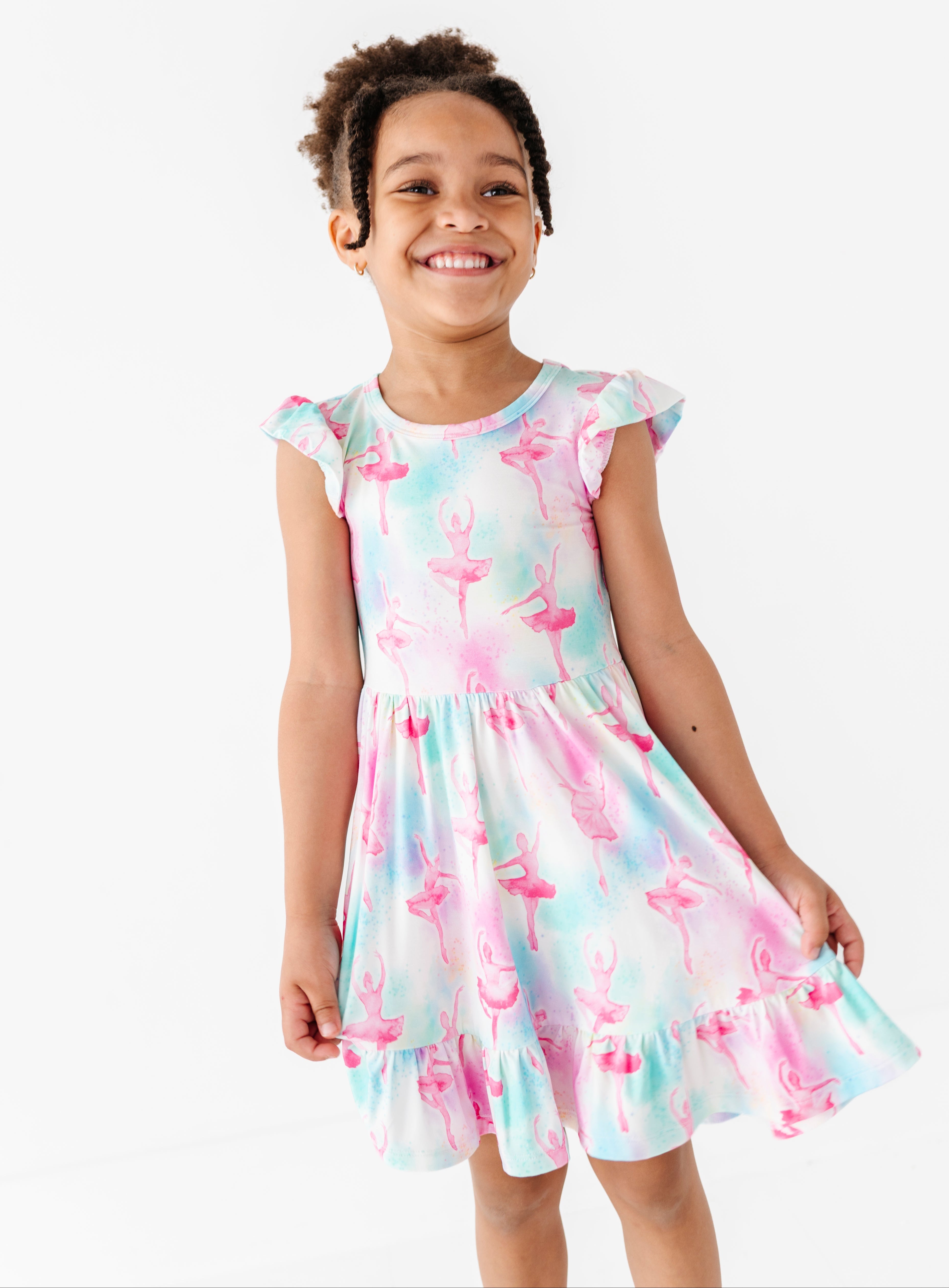Young girl wearing a watercolor ballerina dress on a white background